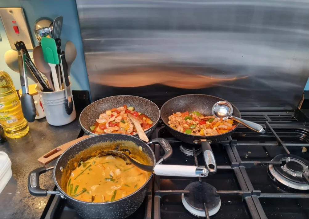 Thai curry and stir-fried dishes cooking on Kate's stove